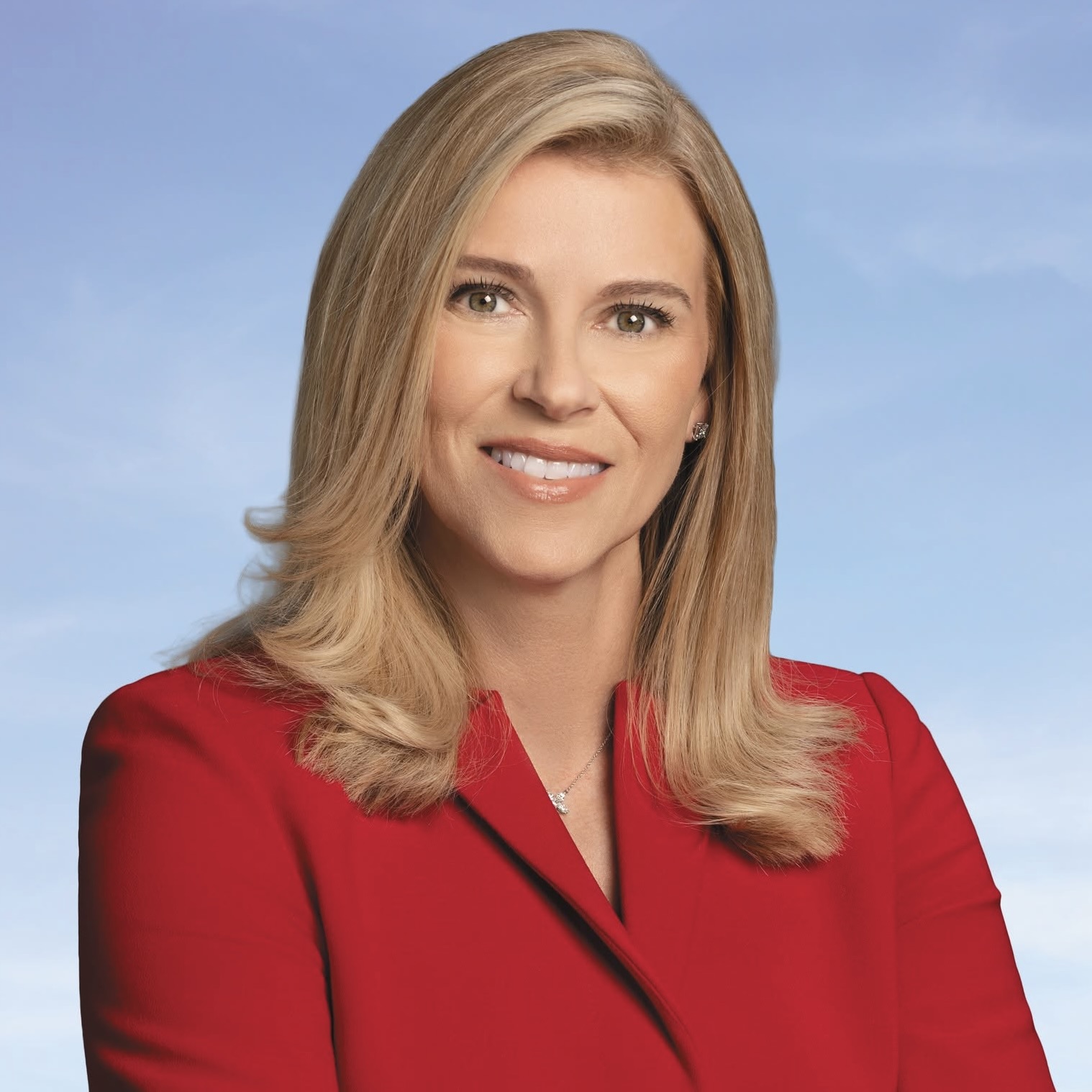This is an image of Leela Gray, candidate for Florida's 13th Congressional District. She is pictured in a red suit in front of a blue background.